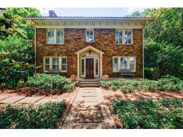 Charming brick home featuring manicured landscaping, a welcoming entrance, and classic architectural details at 27 S Avondale Rd, Avondale Estates, GA 30002