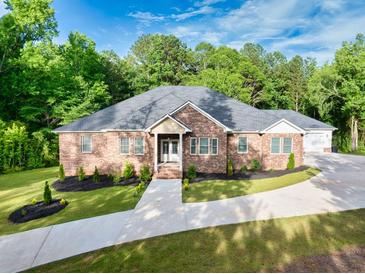 Charming brick home with well-manicured lawn and inviting walkway leading to the entrance at 338 Mount Zion Rd, Oxford, GA 30054