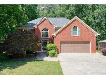 Charming two-story brick home with a two-car garage and a well-manicured front yard at 109 Lake Latimer Ne Cv, Kennesaw, GA 30144