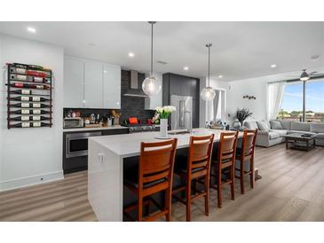 Modern kitchen features a large island with seating and stainless steel appliances at 788 W Marietta Nw St # 308, Atlanta, GA 30318