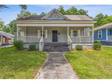 Charming home featuring a covered front porch and a well-maintained lawn at 1365 Athens Sw Ave, Atlanta, GA 30310