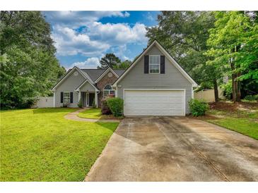 Charming single-Gathering home with a well-maintained lawn and attached two-car garage at 556 Walton Dr, Social Circle, GA 30025