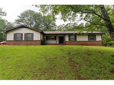 Charming one-story home with a brick foundation, neutral siding, and a well-manicured lawn at 265 Forest Lake Dr, Covington, GA 30016