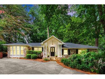 Charming brick home with lush landscaping, inviting entrance, and a well-maintained front yard at 5114 N Ivy Ne Rd, Atlanta, GA 30342