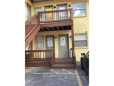 Two-story apartment building features gray doors and brown stairs to the second level at 561 Formwalt Sw St # 7, Atlanta, GA 30312