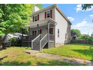 Charming two-story home featuring a covered front porch and well-maintained yard at 1902 Memorial Se Dr, Atlanta, GA 30317