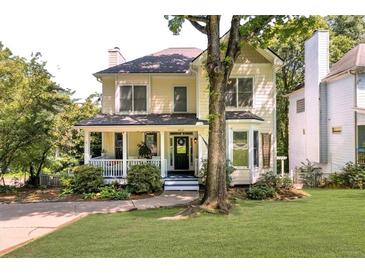 Charming two-story home with a welcoming front porch and a well-maintained lawn at 2653 W Main Nw St, Atlanta, GA 30318
