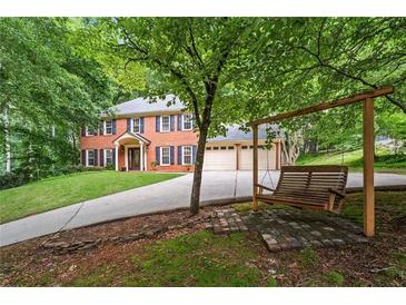 Charming two-story brick home with a three-car garage and a welcoming swing set at 1863 Wicks Valley Ne Dr, Marietta, GA 30062