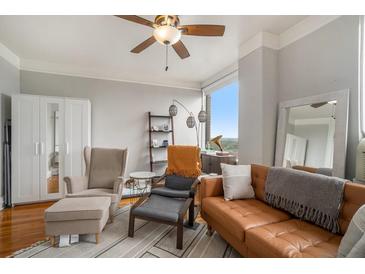 Inviting living room with hardwood floors, ceiling fan, and a comfortable leather sofa at 75 Ponce De Leon Ne Ave # 1004, Atlanta, GA 30308