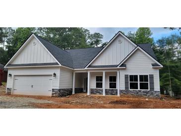 Charming single-Gathering home with stone accents, covered porch, attached garage, and a well-manicured lawn at 5502 Lakeview Parkway, Villa Rica, GA 30180