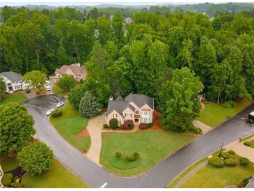 Stunning two-story brick home with lush landscaping and mature trees in a desirable neighborhood at 2759 Thomashire Trce, Marietta, GA 30066