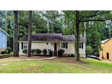 Charming single-story home with a well-maintained lawn and mature trees at 3646 Salem Dr, Lithonia, GA 30038