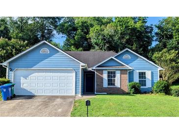 Charming one-story home with blue siding, brick accents, attached garage and well-maintained lawn at 1513 Foxhall Se Ln, Atlanta, GA 30316
