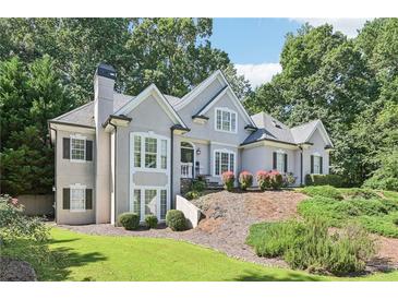 Charming two-story home featuring a stucco exterior and lush landscaping, perfect for curb appeal at 4472 Cavallon Nw Way, Acworth, GA 30101