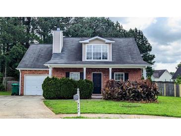 Charming one-story brick home with a well-maintained lawn and covered entrance at 4707 Golod Way, Lithonia, GA 30038