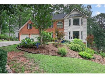 Charming home with a well-maintained front yard and garden landscaping at 2206 Heritage Trace Dr, Marietta, GA 30062