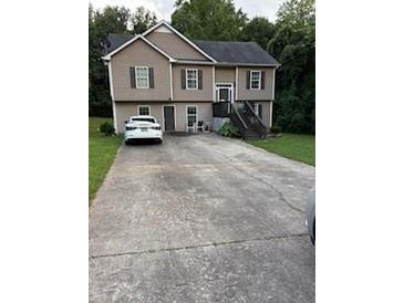 Two-story home with neutral siding, double windows, and extended driveway at 120 Alfred Dr, Carrollton, GA 30116