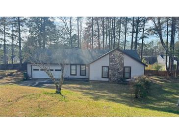 Charming single-story home featuring stone accents, attached garage, and a well-maintained front lawn at 5359 Stafford Nw Dr, Lilburn, GA 30047