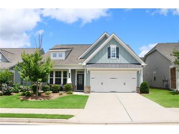 Charming home with blue siding, well-manicured lawn, and a two-car garage at 605 Oak Ln, Canton, GA 30114