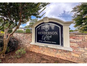 Stone sign for Henderson Park Condominiums with manicured landscaping on a partially cloudy day at 3301 Henderson Mill Rd # Aa3, Atlanta, GA 30341