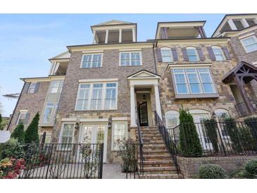 Elegant townhome with stone and brick facade, rooftop terrace, and inviting front entrance at 1117 Cordia Ave, Atlanta, GA 30318