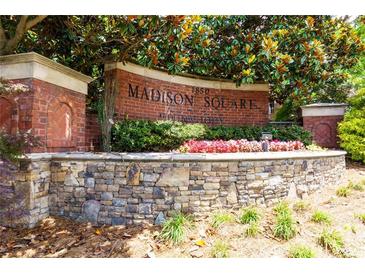 Attractive brick sign for Madison Square at Auburn Woods community entrance framed by colorful landscaping at 1850 Cotillion Drive # 2118, Dunwoody, GA 30338