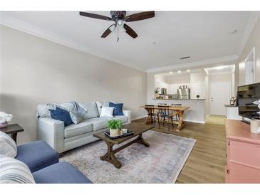 Inviting living room with open floorplan features stylish furniture and hardwood flooring at 1850 Cotillion Drive # 2118, Dunwoody, GA 30338