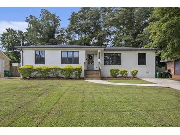 Charming one-story home featuring a white exterior, well-manicured lawn, and inviting curb appeal at 3135 Bluebird Ln, Decatur, GA 30032