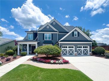 Beautiful two-story home with a well-manicured lawn, colorful flower beds and a two-car garage at 3804 Bay Orchard Lane, Loganville, GA 30052