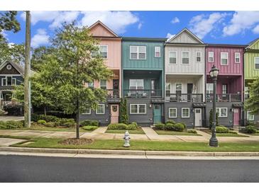 Colorful townhomes with manicured lawns and sidewalks create inviting curb appeal at 2016 Bixby Byway Se Dr, Atlanta, GA 30317
