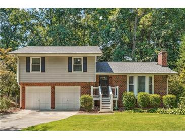 Charming two-story home with a brick and siding exterior, attached two-car garage, and landscaped front yard at 190 Windflower Trce, Roswell, GA 30075