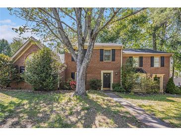 Charming brick two-story home with a beautiful front yard, mature tree, and inviting entrance at 1272 Whitlock Ridge Drive Sw Dr, Marietta, GA 30064