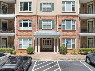 Brick building exterior featuring balconies, ample parking, and well-maintained landscaping at 2303 Stratford Commons Commons, Decatur, GA 30033