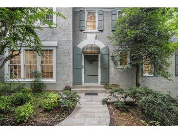 Charming front door with a stone walkway and lush landscaping at 80 Stratford Ne Pl, Atlanta, GA 30342