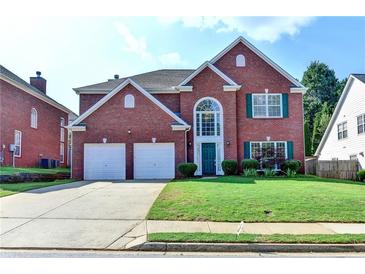 Charming brick two-story home with attached two car garage and well manicured lawn at 2765 Turning Leaf Dr, Lawrenceville, GA 30044