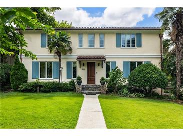 Charming two-story home with blue shutters, lush lawn, and mature trees giving great curb appeal at 2837 N Hills Ne Dr, Atlanta, GA 30305