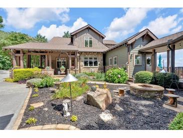Beautiful home featuring a stone fire pit and lush landscaping at 52 Waterside Se Dr, Cartersville, GA 30121