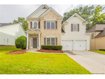 Charming two-story home featuring a well-manicured lawn and inviting entrance at 98 Coopers Glen Sw Dr, Mableton, GA 30126