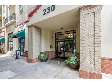 Inviting building entrance with planters and brick accents, showcasing the stylish facade at 230 E Ponce De Leon Ave # 324, Decatur, GA 30030