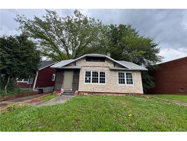 Charming single-story home featuring stone veneer, a metal roof and a yard, ready for personalization at 1422 Boulevard Se, Atlanta, GA 30315
