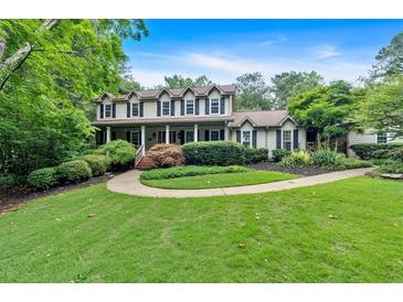 Inviting two-story home with a charming front porch and meticulously landscaped front yard at 3656 Ebenezer Rd, Marietta, GA 30066