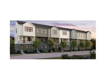Beautiful modern townhome complex with multiple units, white siding and black window accents, set amongst green trees at 434 Argosy Park Cir # 13, Alpharetta, GA 30005