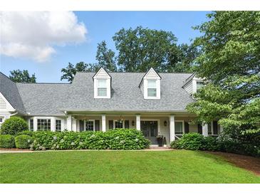 Charming home featuring a well-manicured lawn and beautiful landscaping, enhancing its curb appeal at 4824 Dunwoody Station Dr, Atlanta, GA 30338