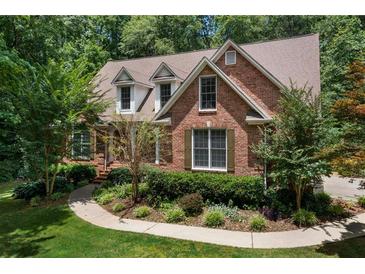 Charming brick home featuring lush landscaping, dormer windows and a well-manicured lawn at 17 Shotgun Nw Rd, Cartersville, GA 30121