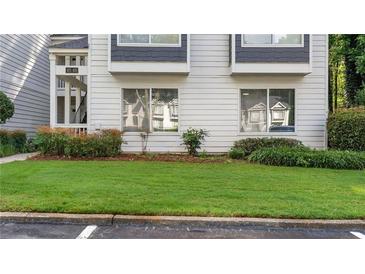 Charming exterior of a two-story condo with well-maintained lawn and landscaping at 47 Arbor End, Smyrna, GA 30080