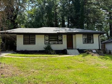 Charming single-story home with a well-maintained lawn and inviting curb appeal at 1968 Rosewood Rd, Decatur, GA 30032