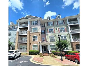Charming three-story condo with colorful facades, balconies, and well-maintained landscaping at 1975 Nocturne Dr # 2206, Alpharetta, GA 30009