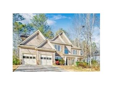 Charming two-story home with a three-car garage and stone detailing on the exterior at 380 Victorian Ln, Duluth, GA 30097