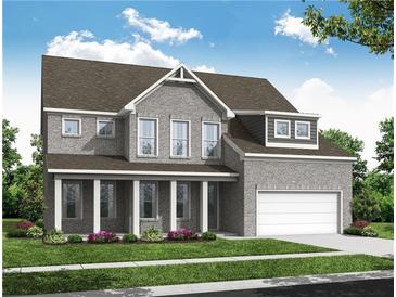 Charming two-story home features a brick facade, covered porch with columns, and an attached two-car garage at 900 Melody Ridge Ln, Buford, GA 30518
