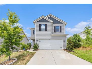 Charming two-story home with a well-maintained lawn, two car garage, and inviting curb appeal at 3350 Clawing Hawk Way, Douglasville, GA 30135